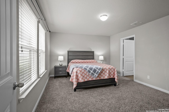 bedroom with carpet flooring, baseboards, and visible vents