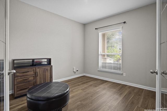 interior space with wood finished floors and baseboards