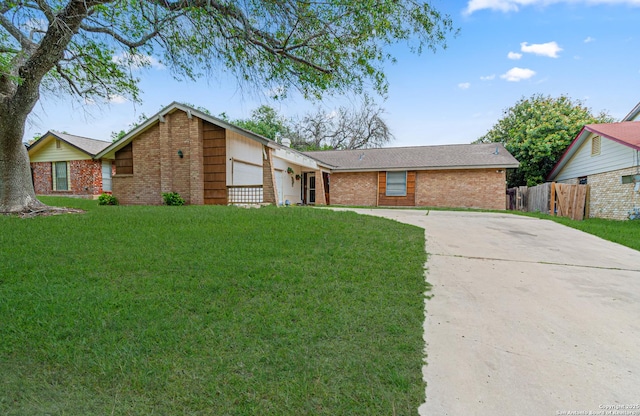 13018 Larkyorke, San Antonio, TX 78233 - view of front of home featuring concrete driveway, an attached garage, brick siding, and a front yard