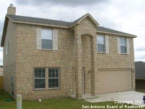 3430 Longhorn, San Antonio, TX 78261 - view of front facade with an attached garage, a chimney, stone siding, and driveway