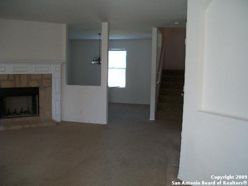 3430 Longhorn, San Antonio, TX 78261 - unfurnished living room with carpet flooring and a tiled fireplace