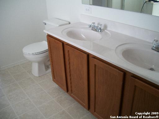 3430 Longhorn, San Antonio, TX 78261 - full bathroom with a sink, double vanity, and toilet