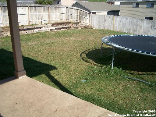 3430 Longhorn, San Antonio, TX 78261 - view of yard with a fenced backyard and a trampoline