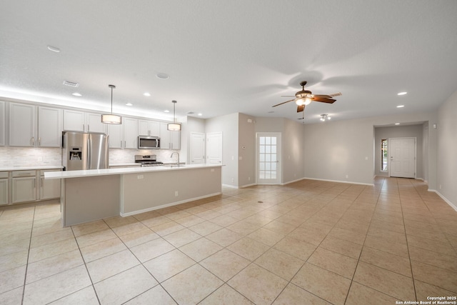 kitchen with recessed lighting, a healthy amount of sunlight, stainless steel appliances, and light tile patterned flooring