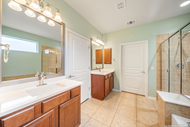 bathroom featuring visible vents, a stall shower, and a sink