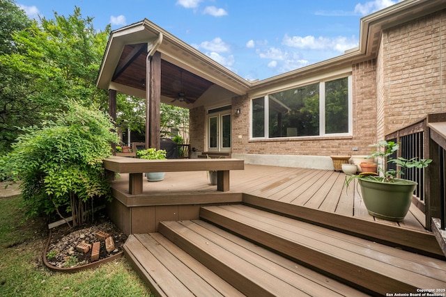 wooden terrace with a ceiling fan
