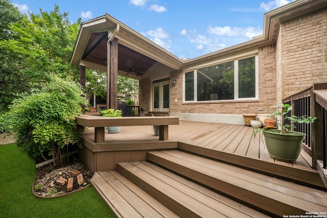 wooden deck featuring a ceiling fan