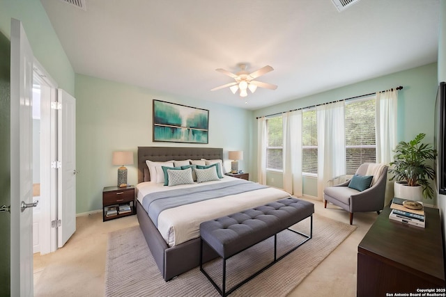 bedroom featuring light carpet, baseboards, visible vents, and ceiling fan