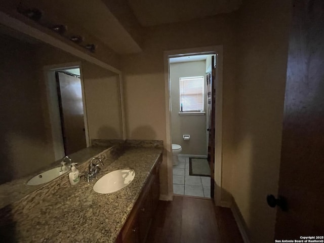 310 Seven Seas, Crosby, TX 77532 - bathroom with vanity, toilet, baseboards, and wood finished floors