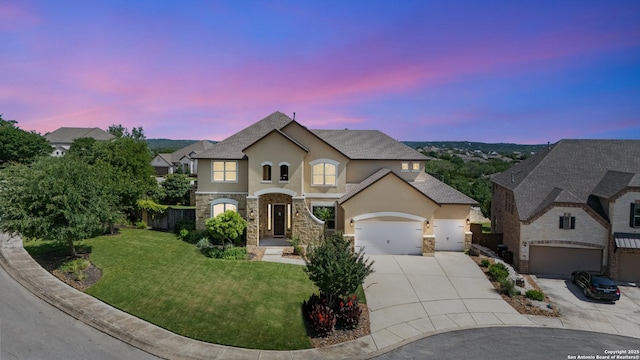 28546 Tristant Rdg, San Antonio, TX 78260 - view of front facade featuring an attached garage, stone siding, driveway, stucco siding, and a front lawn