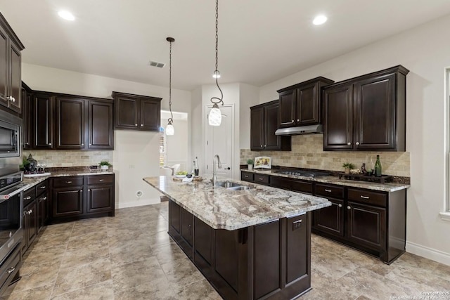 28546 Tristant Rdg, San Antonio, TX 78260 - kitchen with under cabinet range hood, baseboards, light stone counters, a sink, and appliances with stainless steel finishes