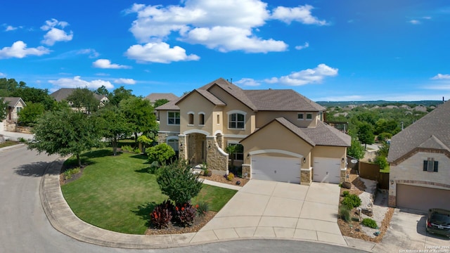 28546 Tristant Rdg, San Antonio, TX 78260 - view of front of house with driveway, an attached garage, stucco siding, stone siding, and a front lawn