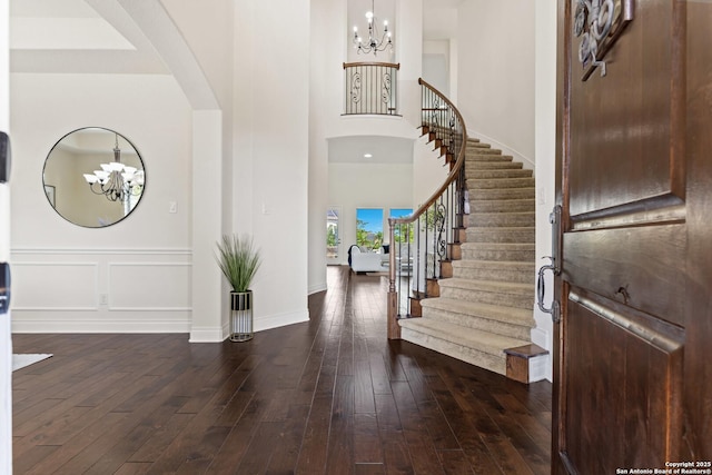 28546 Tristant Rdg, San Antonio, TX 78260 - entryway with arched walkways, dark wood-style flooring, stairway, and an inviting chandelier