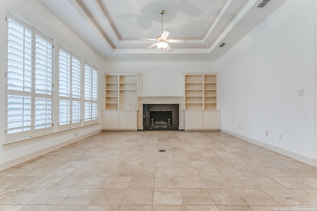 9 Waldenshire, San Antonio, TX 78209 - unfurnished living room with baseboards, visible vents, ceiling fan, a raised ceiling, and a fireplace