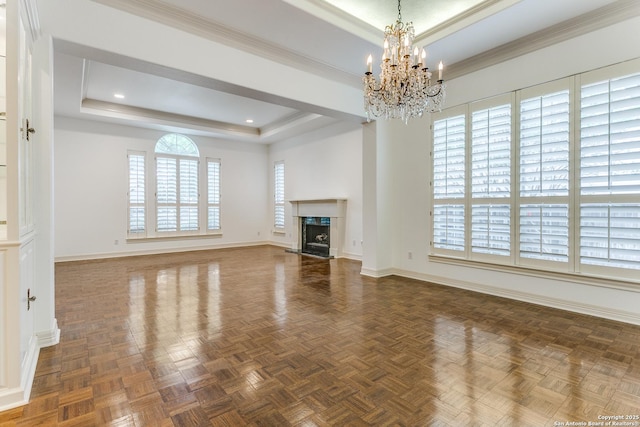 9 Waldenshire, San Antonio, TX 78209 - unfurnished living room with a chandelier, baseboards, a raised ceiling, and a premium fireplace