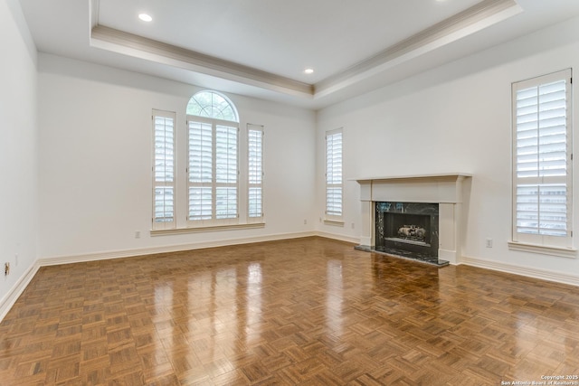 9 Waldenshire, San Antonio, TX 78209 - unfurnished living room with a tray ceiling, a wealth of natural light, baseboards, and a premium fireplace