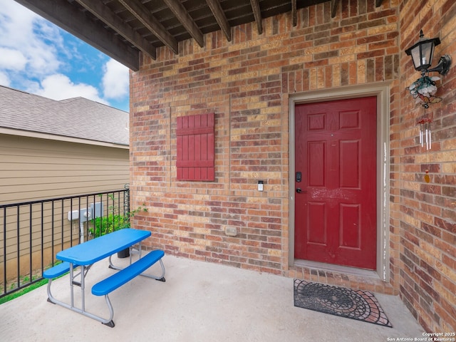 property entrance featuring brick siding