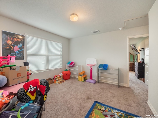 game room featuring attic access, visible vents, carpet, and a wealth of natural light