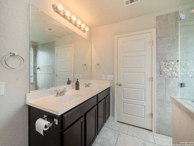 full bath with tile patterned flooring, visible vents, and a sink