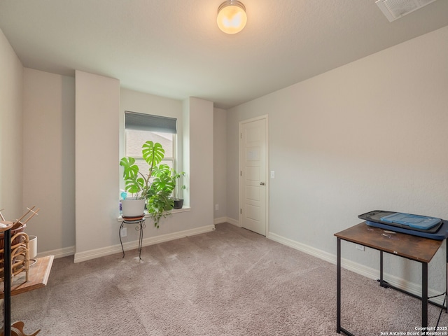 interior space with carpet floors, baseboards, and visible vents