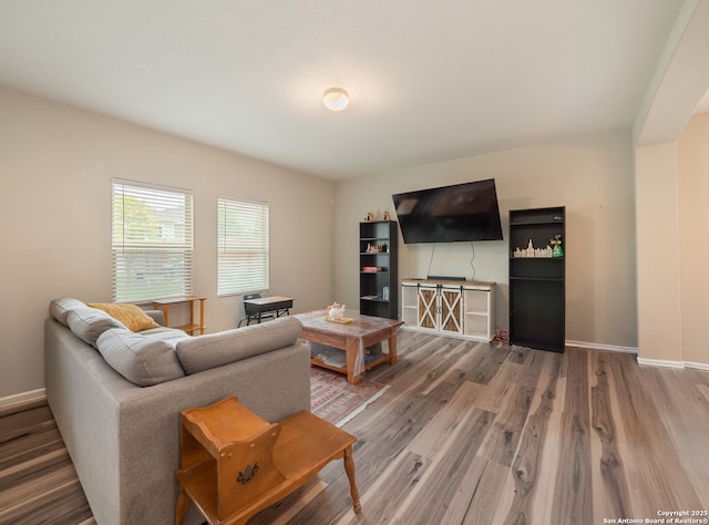 living room with wood finished floors and baseboards