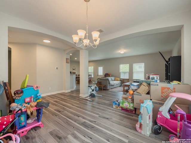 game room with a notable chandelier, recessed lighting, visible vents, wood finished floors, and arched walkways