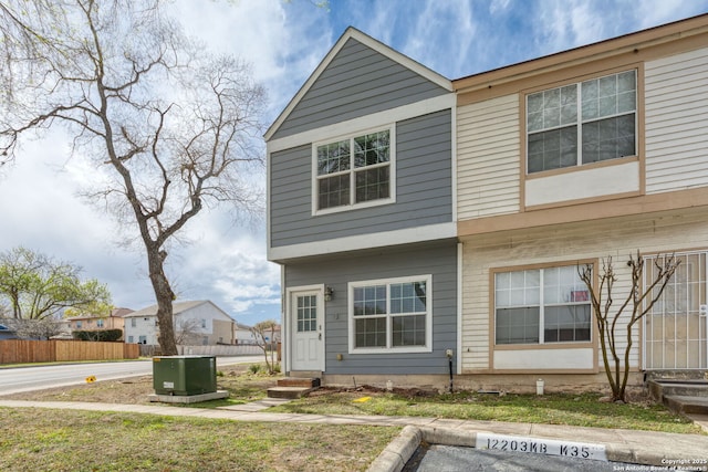 exterior space featuring uncovered parking, fence, and entry steps