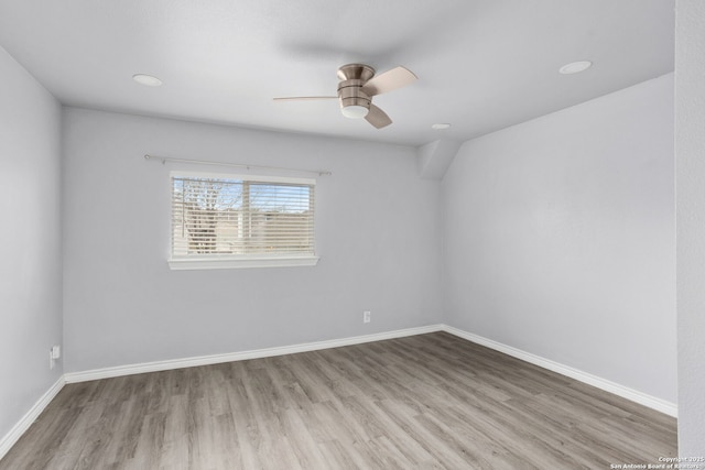 spare room featuring a ceiling fan, baseboards, and wood finished floors