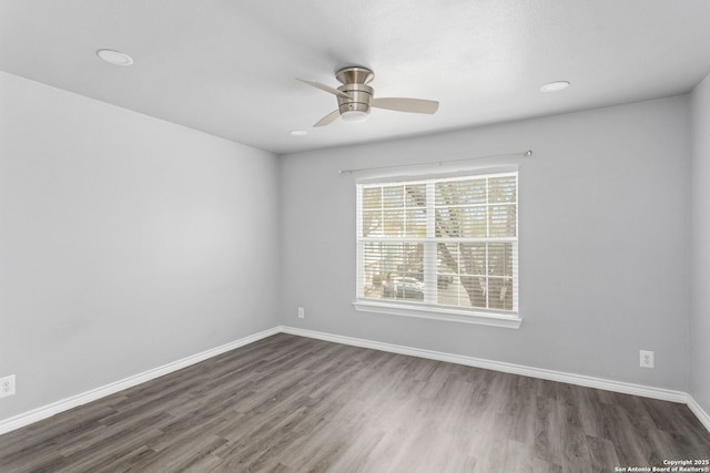spare room featuring ceiling fan, dark wood-style flooring, baseboards, and recessed lighting