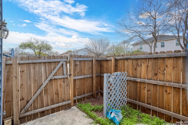 view of yard featuring fence and a gate