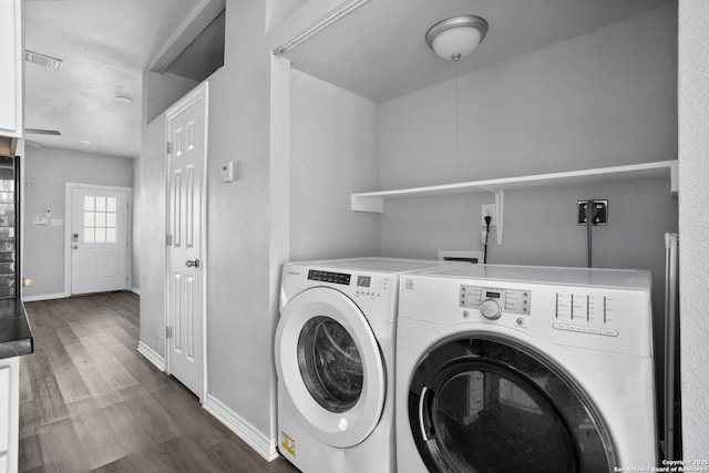 laundry room with separate washer and dryer, laundry area, dark wood finished floors, and baseboards