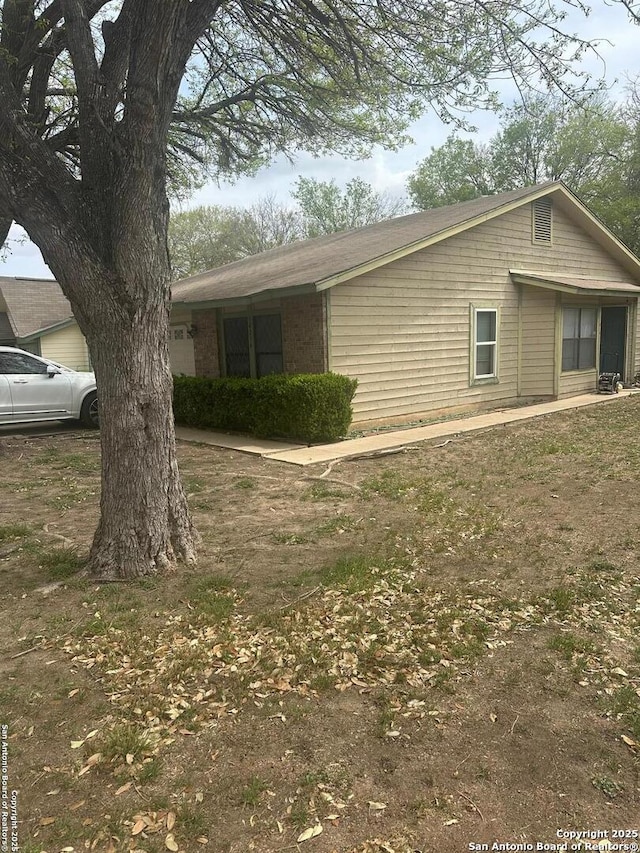 view of side of property with brick siding