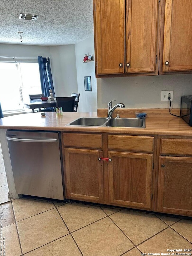 kitchen with light countertops, a sink, visible vents, dishwasher, and black microwave