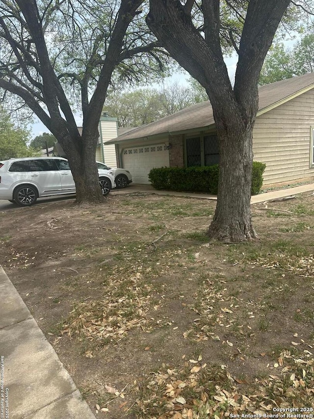 view of yard featuring an attached garage