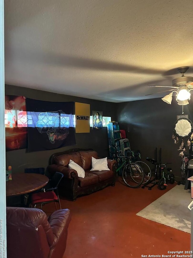 living area with finished concrete floors, a textured ceiling, and a ceiling fan