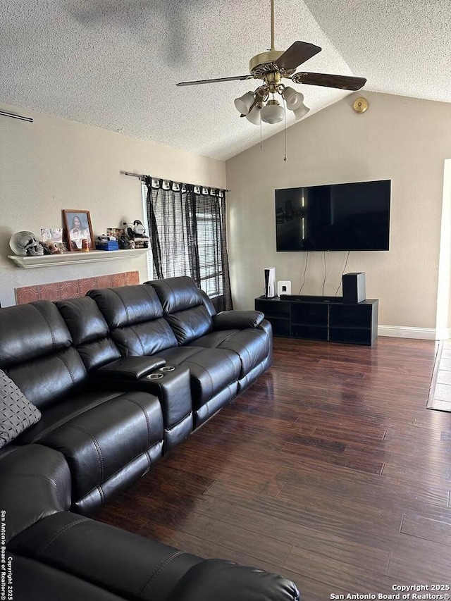 living room with wood finished floors, a textured ceiling, vaulted ceiling, a ceiling fan, and baseboards
