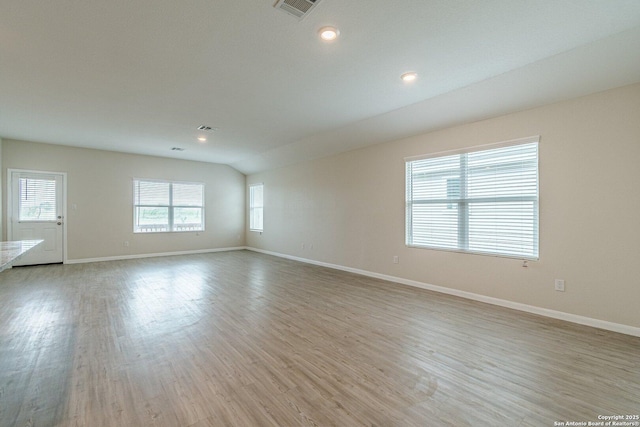 interior space with light wood-style floors, visible vents, baseboards, and recessed lighting