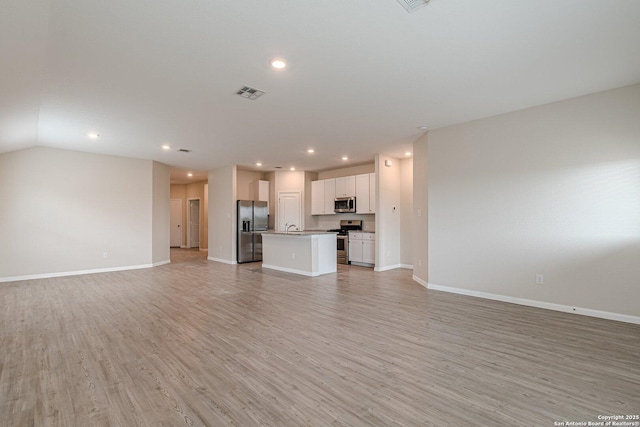 unfurnished living room featuring light wood-type flooring, visible vents, baseboards, and recessed lighting