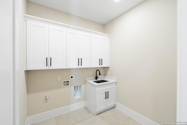 115 Heartland, Boerne, TX 78006 - washroom featuring a sink, cabinet space, hookup for an electric dryer, hookup for a washing machine, and baseboards