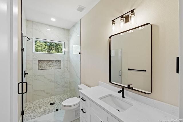 115 Heartland, Boerne, TX 78006 - bathroom featuring toilet, a marble finish shower, visible vents, marble finish floor, and vanity