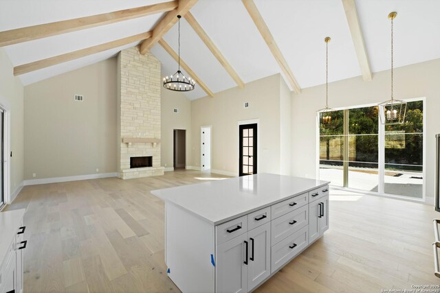 115 Heartland, Boerne, TX 78006 - kitchen with beamed ceiling, a notable chandelier, light wood-style flooring, and high vaulted ceiling