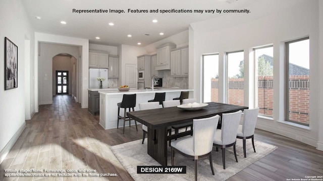 12949 Gilmore Bnd, San Antonio, TX 78245 - dining area with recessed lighting, arched walkways, baseboards, and light wood-style floors