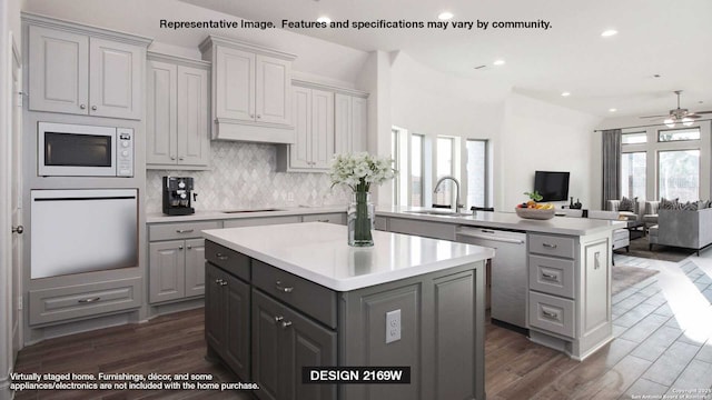12949 Gilmore Bnd, San Antonio, TX 78245 - kitchen with stainless steel dishwasher, a center island, a sink, gray cabinets, and oven