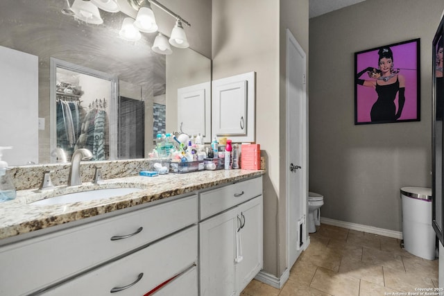 full bathroom featuring toilet, a closet, baseboards, tile patterned flooring, and vanity