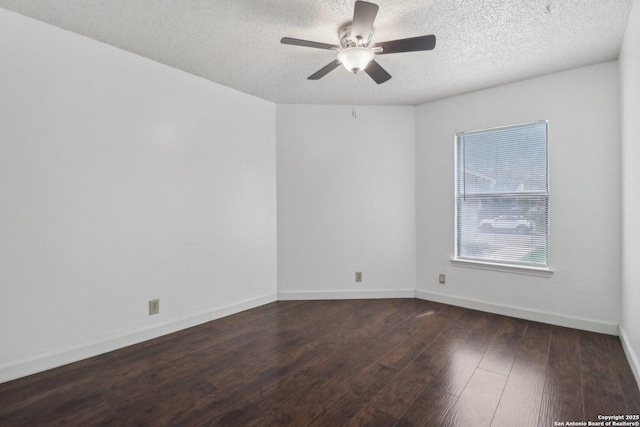 unfurnished room with baseboards, ceiling fan, a textured ceiling, and wood finished floors