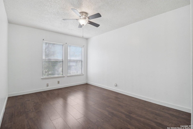 spare room featuring dark wood finished floors, a textured ceiling, baseboards, and a ceiling fan