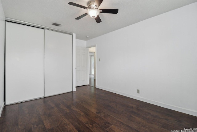 unfurnished bedroom with wood finished floors, a ceiling fan, a closet, visible vents, and baseboards