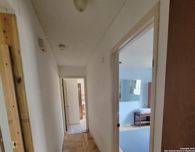 corridor with a textured ceiling