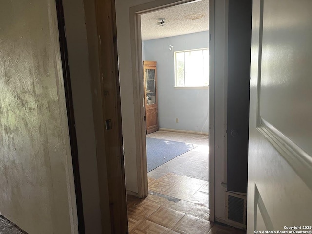 corridor with a textured ceiling