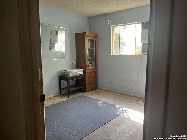 bedroom with multiple windows and a textured ceiling